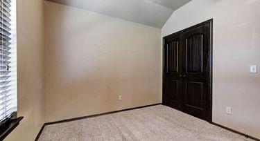 unfurnished bedroom featuring light colored carpet and vaulted ceiling