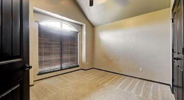 empty room featuring light colored carpet and lofted ceiling