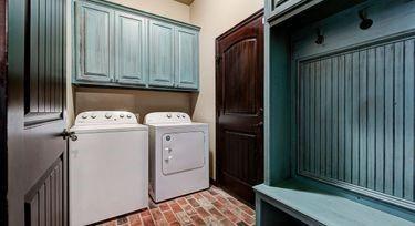 washroom featuring cabinets and independent washer and dryer