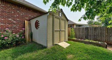 view of outbuilding featuring a lawn