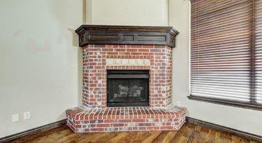 room details featuring a fireplace and wood-type flooring