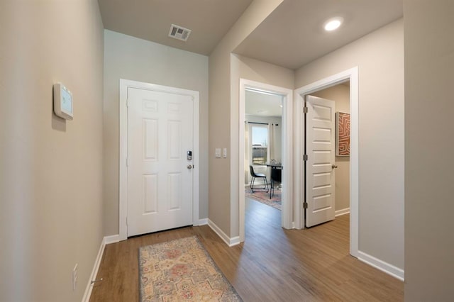 corridor with wood-type flooring