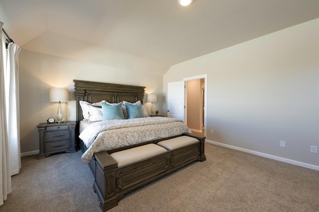 carpeted bedroom featuring lofted ceiling and baseboards