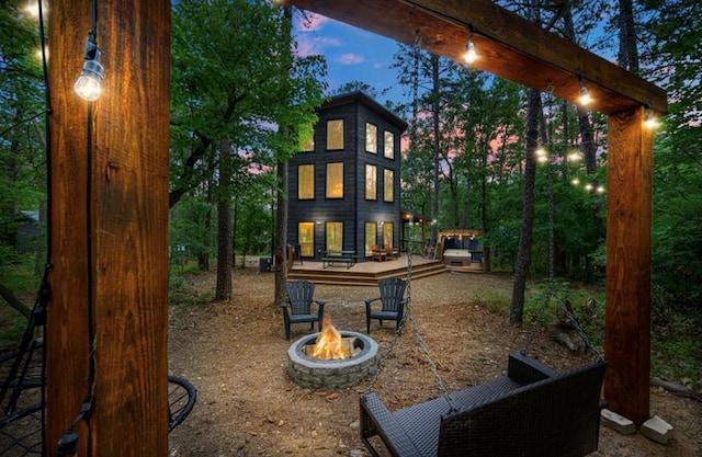 view of jungle gym with a fire pit and a wooden deck