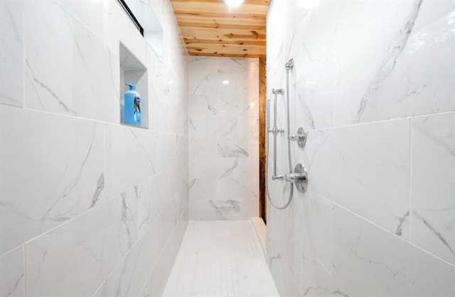 bathroom featuring wooden ceiling and a tile shower