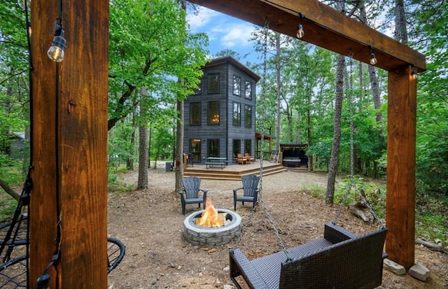 exterior space with an outdoor fire pit and a deck