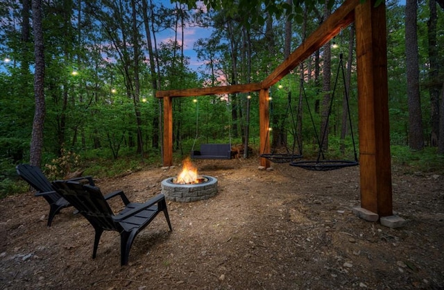 yard at dusk featuring a fire pit