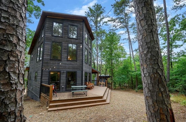 back of property with a wooden deck