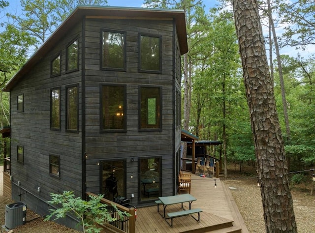 back of property featuring a wooden deck and central AC unit