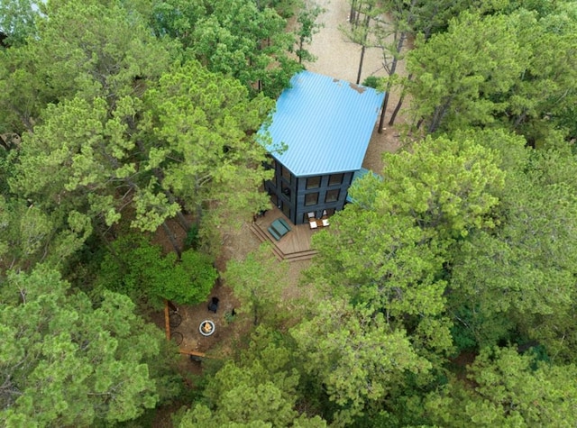 drone / aerial view featuring a wooded view