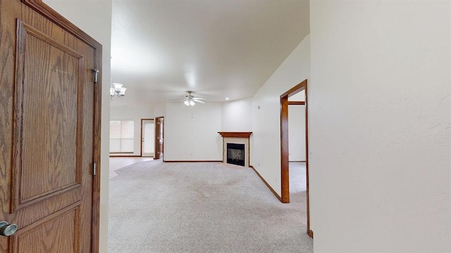 unfurnished living room with light carpet and ceiling fan