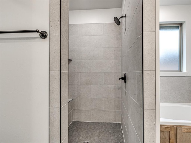 bathroom featuring separate shower and tub