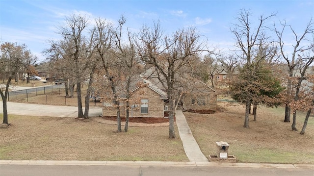 view of front of house featuring concrete driveway and fence