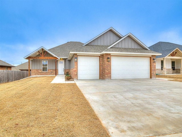 craftsman house with a garage and a front yard