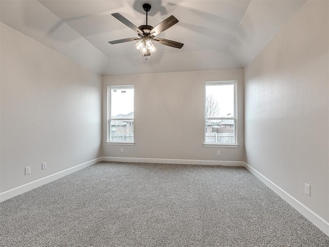 carpeted empty room with ceiling fan and vaulted ceiling