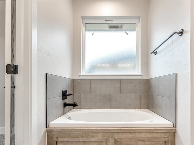 bathroom with tiled tub