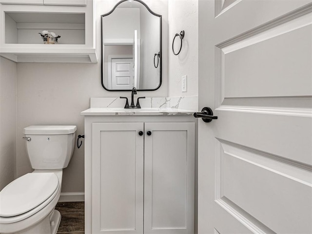 bathroom featuring hardwood / wood-style flooring, vanity, and toilet