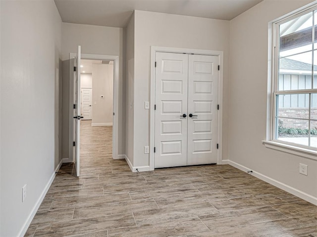 unfurnished bedroom with a closet and light hardwood / wood-style flooring