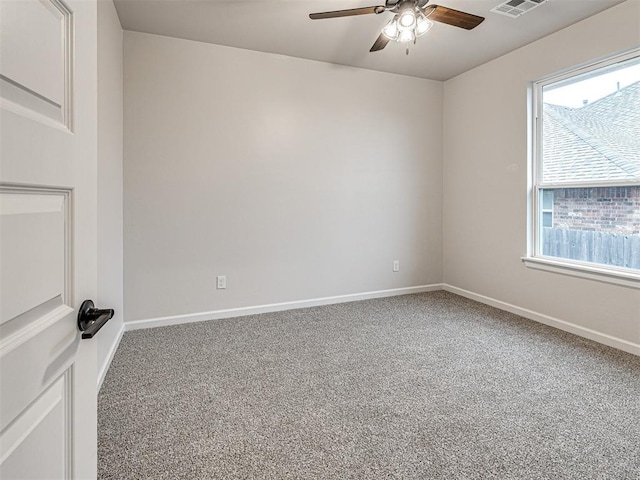 carpeted spare room with ceiling fan