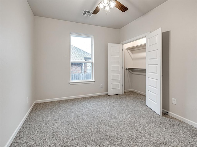 unfurnished bedroom with ceiling fan, carpet floors, and a closet