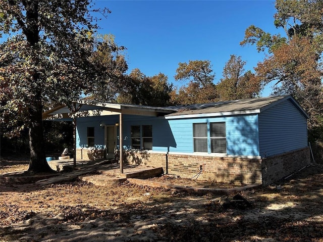 back of property with a patio