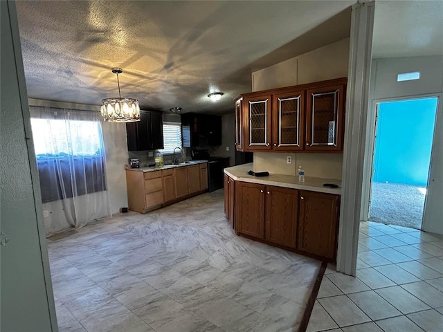 kitchen featuring pendant lighting, sink, a textured ceiling, and an inviting chandelier