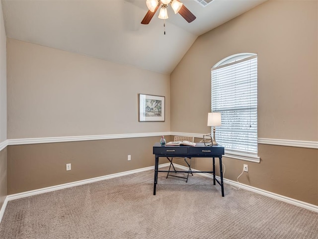 carpeted office space featuring ceiling fan and vaulted ceiling