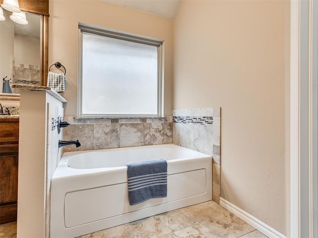 bathroom with vanity, tile patterned flooring, and a washtub