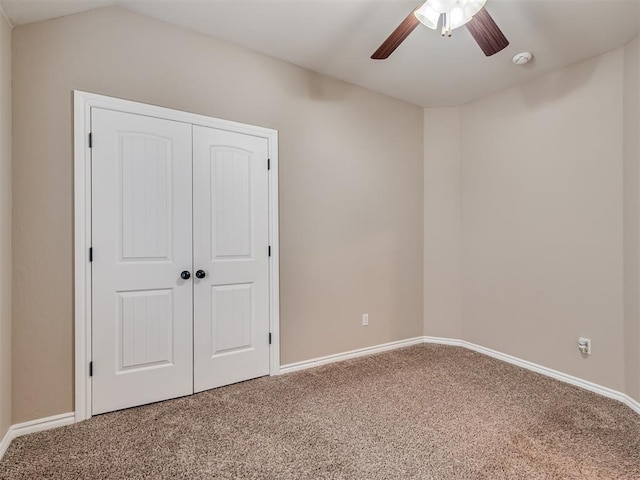 unfurnished bedroom featuring ceiling fan, carpet floors, and a closet