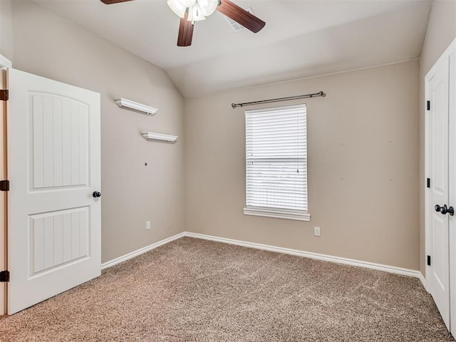 unfurnished bedroom with vaulted ceiling, ceiling fan, and carpet