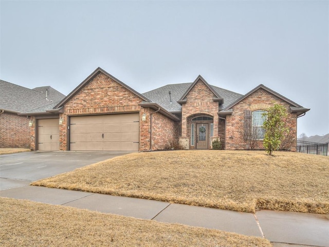 view of front facade with a garage and a front lawn