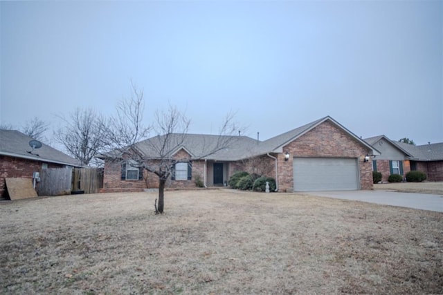 ranch-style house with a garage and a front lawn