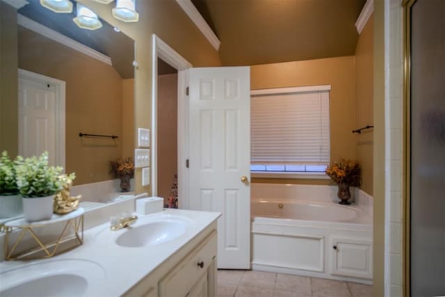 bathroom with tile patterned flooring, vanity, and a bathing tub