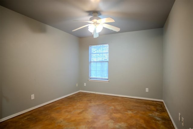 spare room featuring concrete flooring and ceiling fan