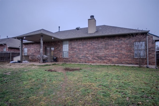 back of house with a yard