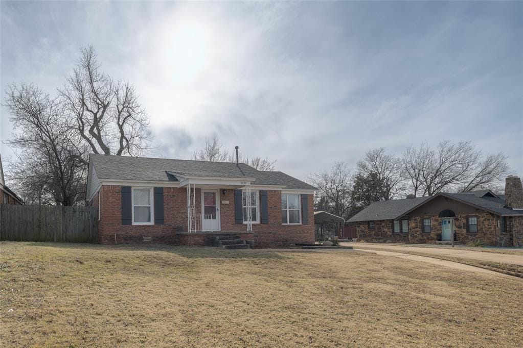 ranch-style house with a front lawn