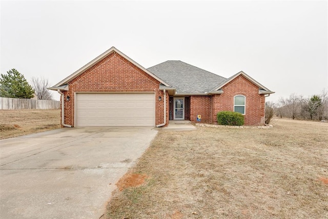 view of front of house featuring a garage and a front yard