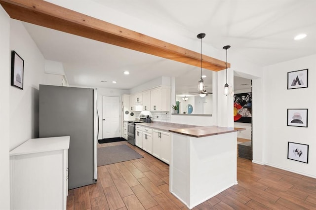 kitchen with pendant lighting, stainless steel appliances, light hardwood / wood-style floors, white cabinets, and kitchen peninsula