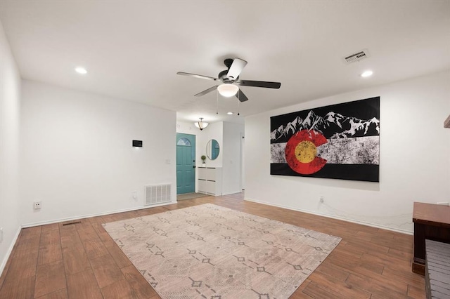 interior space with wood-type flooring and ceiling fan