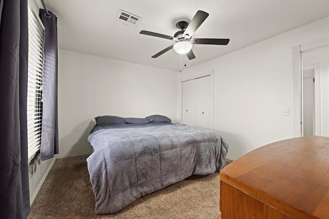 carpeted bedroom featuring a closet and ceiling fan