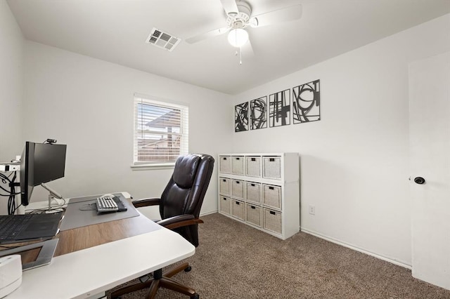 carpeted office space featuring ceiling fan