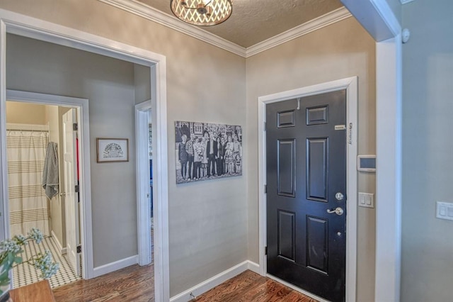 entryway with crown molding, a textured ceiling, and hardwood / wood-style flooring