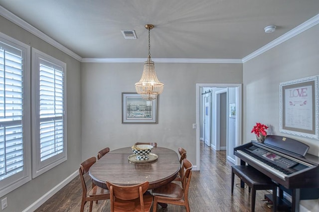 dining room featuring crown molding, dark hardwood / wood-style flooring, and a chandelier