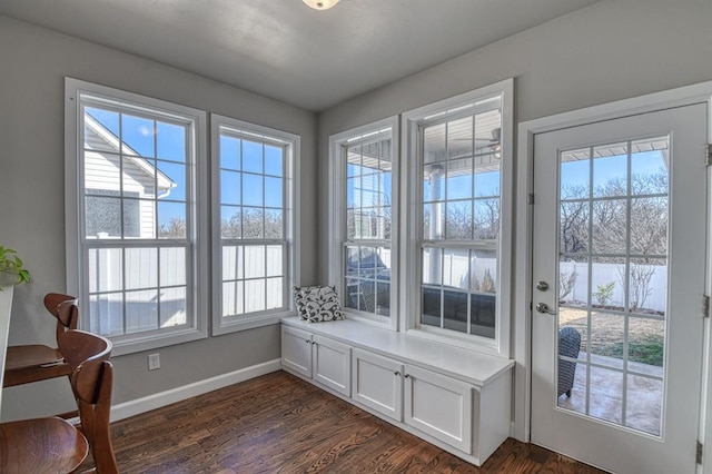 doorway to outside with dark wood-type flooring, a water view, and plenty of natural light