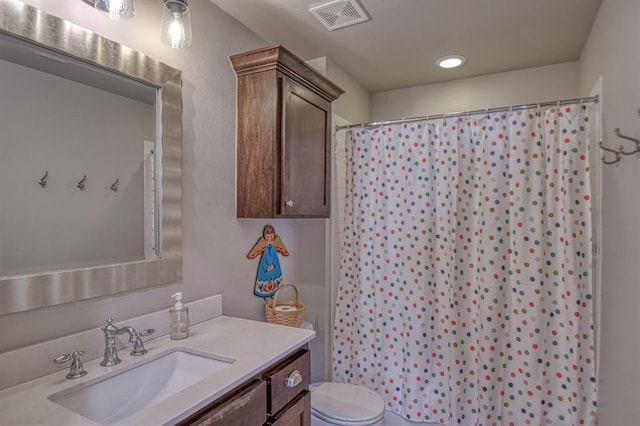 bathroom with vanity, curtained shower, and toilet