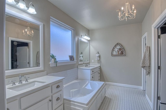 bathroom featuring vanity, a bathing tub, and a notable chandelier