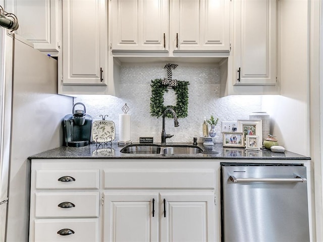 bar with white cabinetry, sink, stainless steel appliances, and dark stone counters