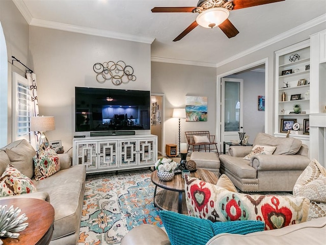 living room with crown molding, wood-type flooring, ceiling fan, and built in shelves