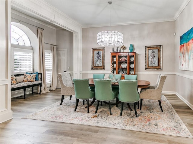 dining room with an inviting chandelier, crown molding, and wood-type flooring