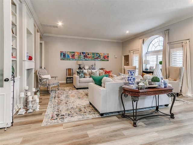 living room featuring crown molding and light hardwood / wood-style floors